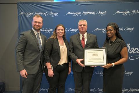 Award of Merit - Mississippi Department of Agriculture and Commerce for publishing a history of the agency. Accepting are Jared Vardaman, Hannah East, and Claude Nash.
