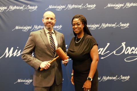 Outgoing President Daphne Chamberlain passes the gavel to incoming President Will Bowlin.