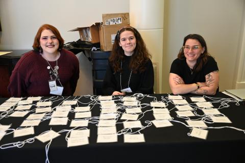 MDAH staff Bently Cochran, Isabella Suell, and MJ Shappley work at the registration table.